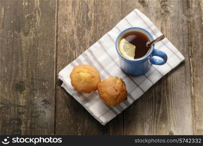 blue Cup of tea with lemon on wooden background