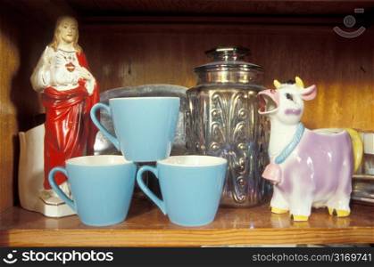 Blue Cups And Tchotchkes on a Shelf