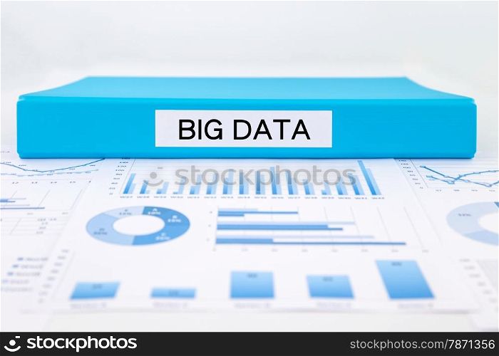 Blue document binder with big data word place on graphs, charts and research reports