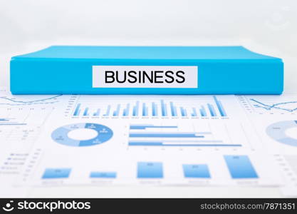 Blue document binder with business word place on graphs and charts of strategic plan