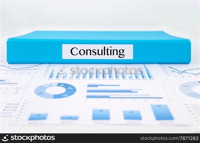Blue document binder with Consulting word place on graphs analysis and business reports