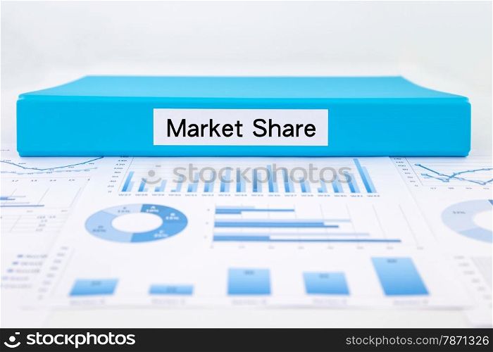 Blue document binder with Market Share word place on graph analysis, charts and Marketing reports
