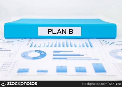 Blue document binder with PLAN B word place on graphs and charts of business plan, solution for project management