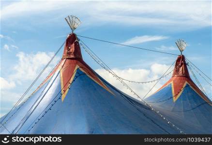 Blue dome of the circus and blue sky. Entertainment concept.