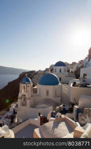 Blue domes and their bell tower in Oia. Santorini