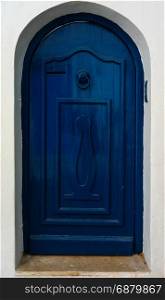 Blue door with ornament and arch from Sidi Bou Said in Tunisia