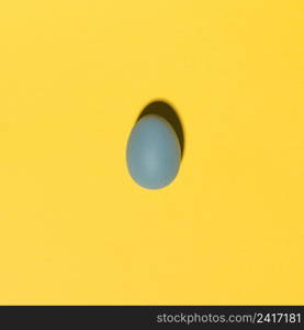 blue easter egg yellow table