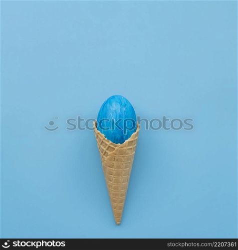 blue egg waffle cone blue background