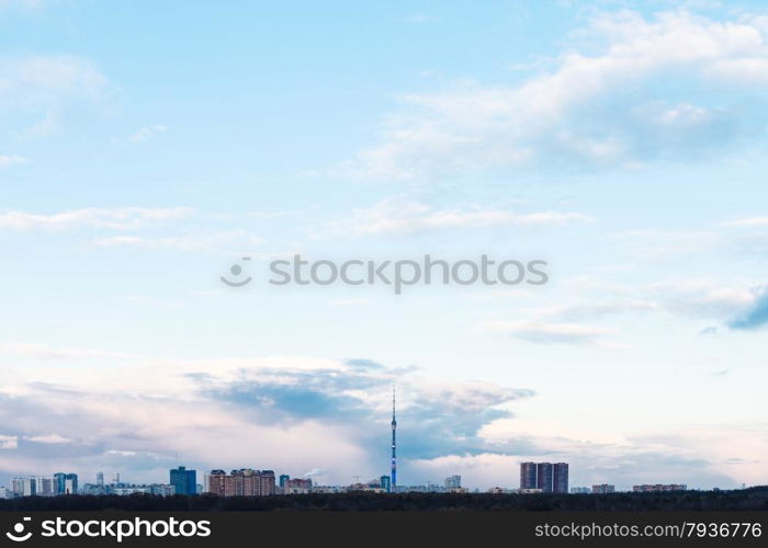 blue evening sky over urban houses in spring sunset