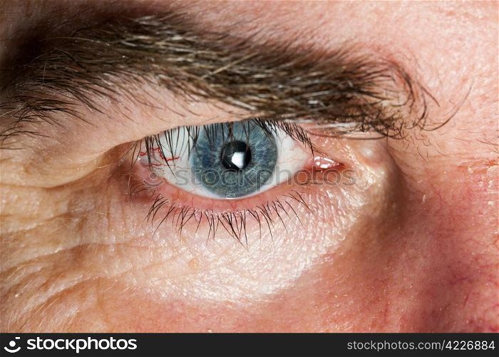 Blue Eye of mature man, close-up horizontal shot