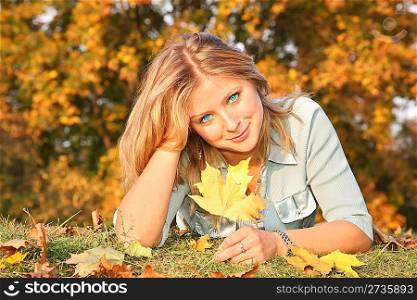blue-eyed blond with the yellow leaf on the grass