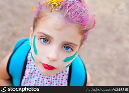blue eyes children girl painted face makeup in outdoor party