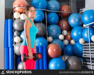 Blue eyes girl at gym weightlifting dumbbells in fitness training