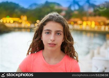 Blue eyes girl portrait at sunset with lights background in a lake