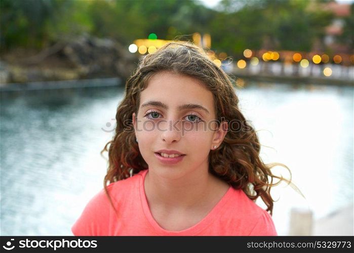 Blue eyes girl portrait at sunset with lights background in a lake