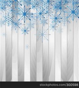 Blue falling snowflakes on grey wooden background. Blue falling snowflakes on wooden background