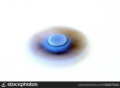 Blue fidget spinner spinning on white background. Fidget spinner spinning on white background