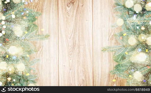 blue  fir tree border on wooden background. fir tree border