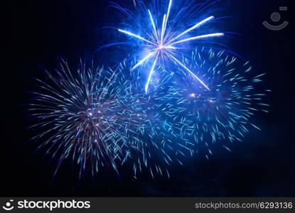 Blue fireworks on the black sky background