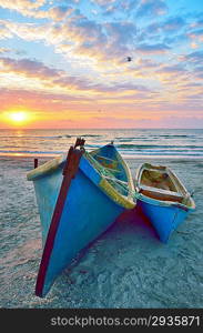 blue fisherman boats and sunrise