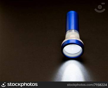 blue flashlight turn on in the dark represent direction searching in unknown situation