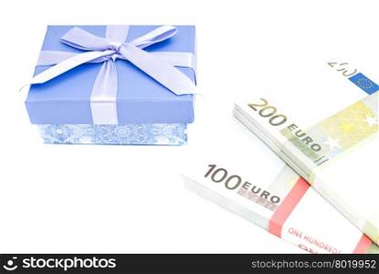 blue gift box and banknotes closeup on white background