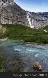 blue glacial water of Briksdal River in Norway