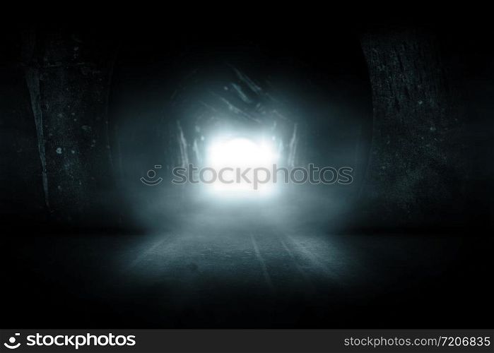 Blue glowing exit from dark abandoned tunnel