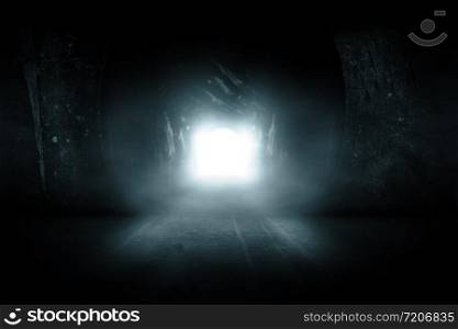 Blue glowing exit from dark abandoned tunnel