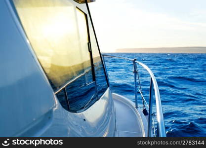 blue golden sunrise sailing on boat side with Mediterranean coastline in horizon