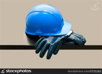 Blue hardhat and leather gloves