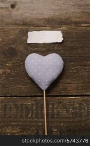 blue heart of the fabric on a dark wooden background. Valentine&#39;s day