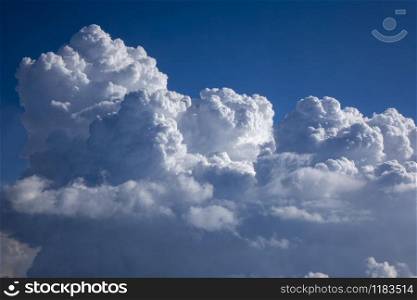 Blue heaven with big cumulus clouds lighted bright sunny beams on a blue clear sky background, copy space. Travel and tourism concept.. Clouds frame as a creative blue sky background.