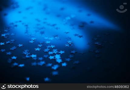 Blue holiday background with shiny night stars, Christmas ornament and new year decoration