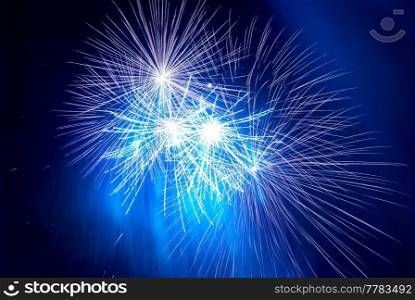 Blue holiday fireworks on black night sky