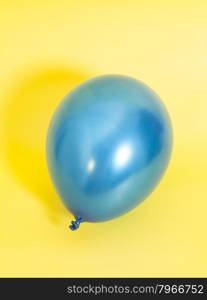 Blue Inflatable balloon on yellow background