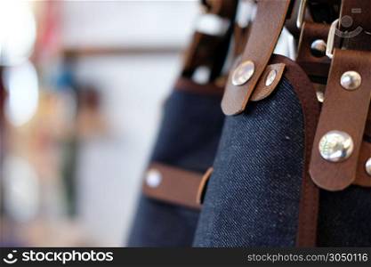 blue jeans denim and brown leather apron