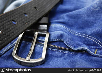 Blue jeans with black leather belt closeup