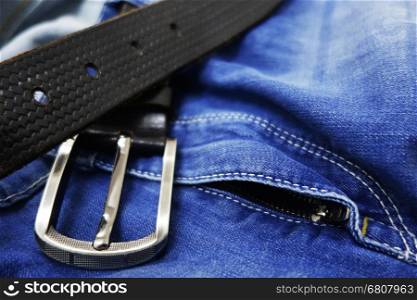 Blue jeans with black leather belt closeup