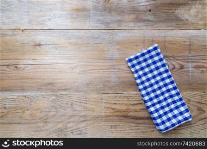 blue kitchen towel on rustic wooden background.. blue kitchen towel on rustic wooden background