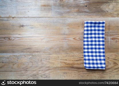 blue kitchen towel on rustic wooden background.. blue kitchen towel on rustic wooden background