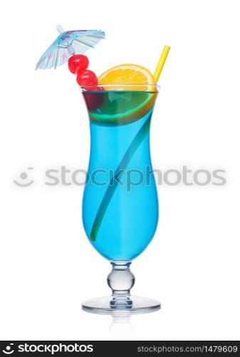 Blue lagoon cocktail classic glass with straw and orange slice with sweet cherry and umbrella on white background.