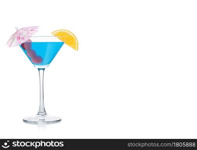 Blue lagoon cocktail in martini glass with orange slice and sweet cherry with umbrella on white background. Space for text