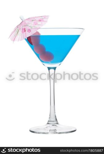Blue lagoon cocktail in martini glass with sweet cherry and umbrella on white background.