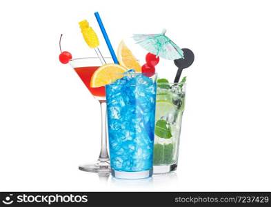 Blue lagoon, cosmopolitan and mojito cocktails glasses with straw and orange slice with sweet cherry and umbrella on white background.