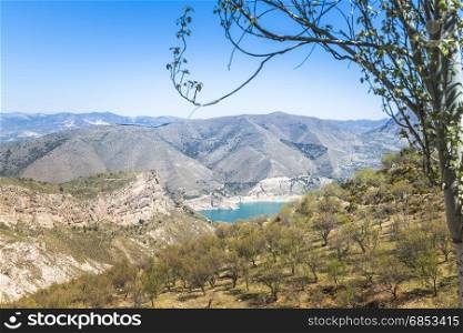 blue lake and hills in the sierra nevada in andalusia spain in summer