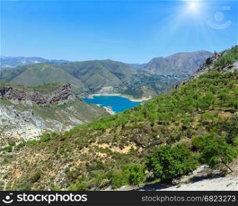 Blue lake in Sierra Nevada National Park, near Granada, Spain. Summer mountain sunshiny landscape.