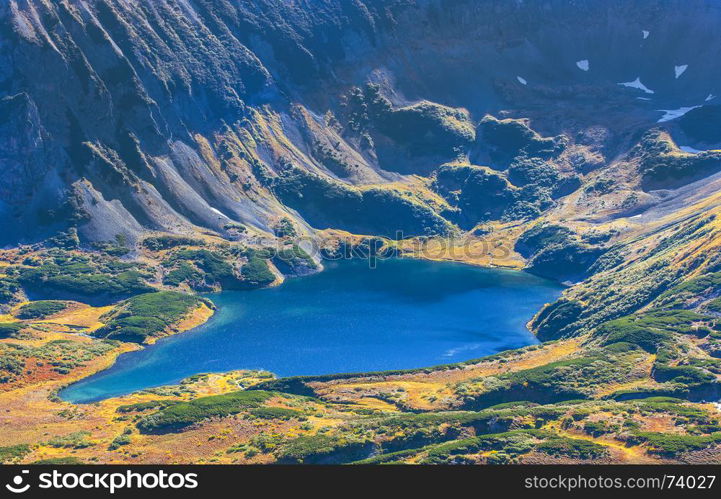 Blue lake in the crater of an extinct volcano in Kamchatka