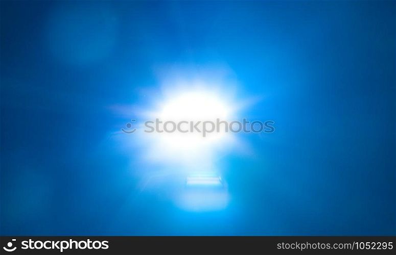 Blue light flare special effect on black background , concert lighting .