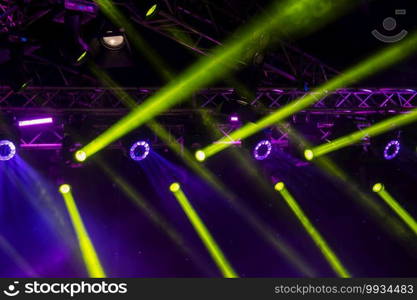 blue luminous rays from concert lighting against a dark background, musical instrument concept